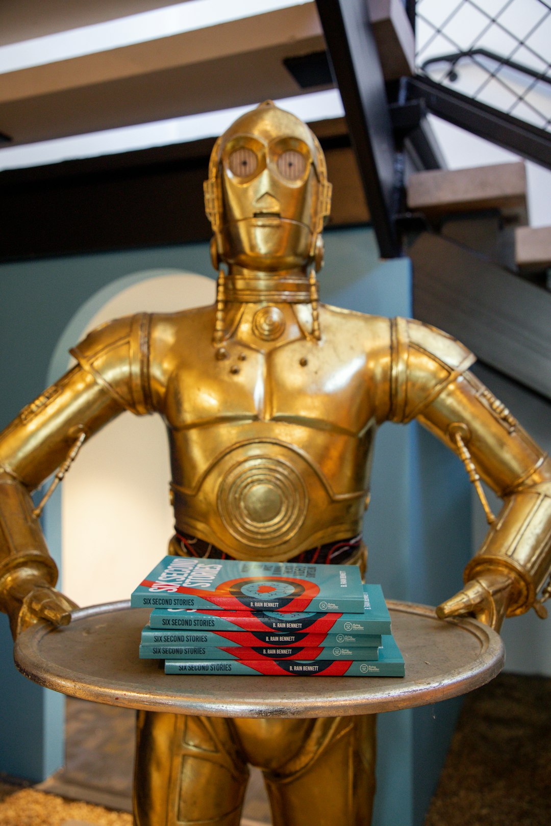 C-3PO serving up a stack of storytelling books.